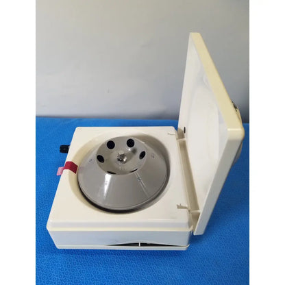 White plastic costar model 10 mini centrifuge with silver fixed position angled metallic rotor and multiple circular slots