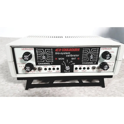 White plastic coulbourn bio system calibrator with black control panel, silver knobs, and red labeling for reuse medical use