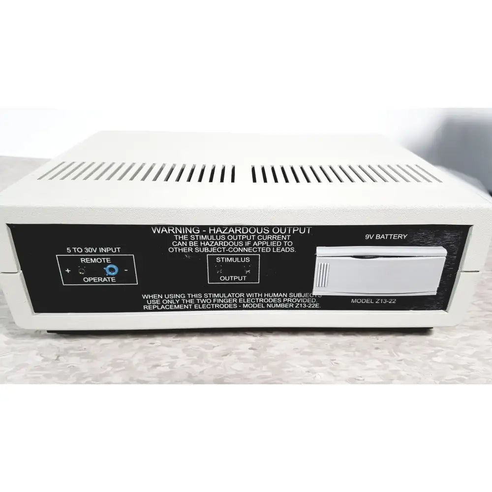 White rectangular coulbourn z13-22 stimulator device with black label and silver battery compartment model z13-22
