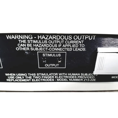 Black plastic output panel of coulbourn z13-22 stimulator with white text and two circular stimulus output ports