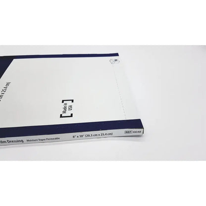White and navy blue covidien 6648kendall transparent film dressing package with dimensions and reference number visible