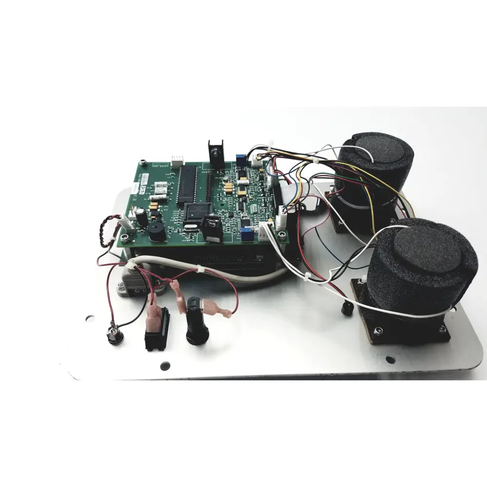 Green circuit board with black components and wires mounted on metallic base of covidien genius 2 checker calibrator