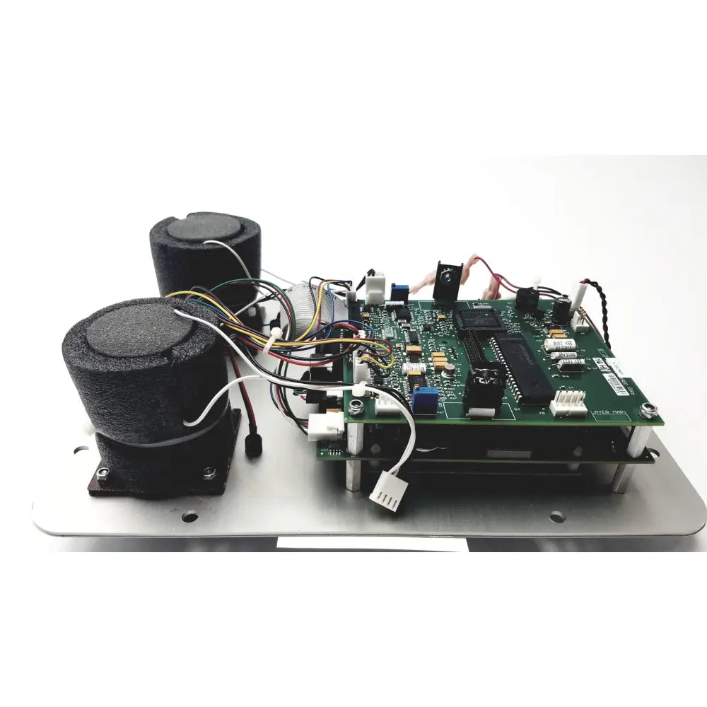 Green circuit board with black components and wires mounted on metallic base of covidien genius 2 checker calibrator for reuse medical use