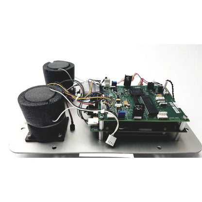 Green circuit board with black components and wires mounted on metallic base of covidien genius 2 checker calibrator for reuse medical use
