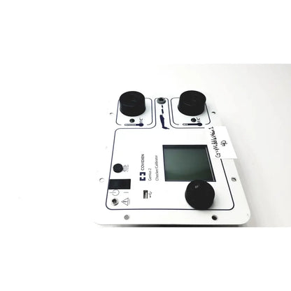 White rectangular covidien genius 2 checker calibrator with black knobs and central digital screen for test meters