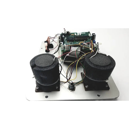 Black cylindrical speakers with foam covers mounted on a metallic plate connected to circuit board of covidien genius checker calibrator