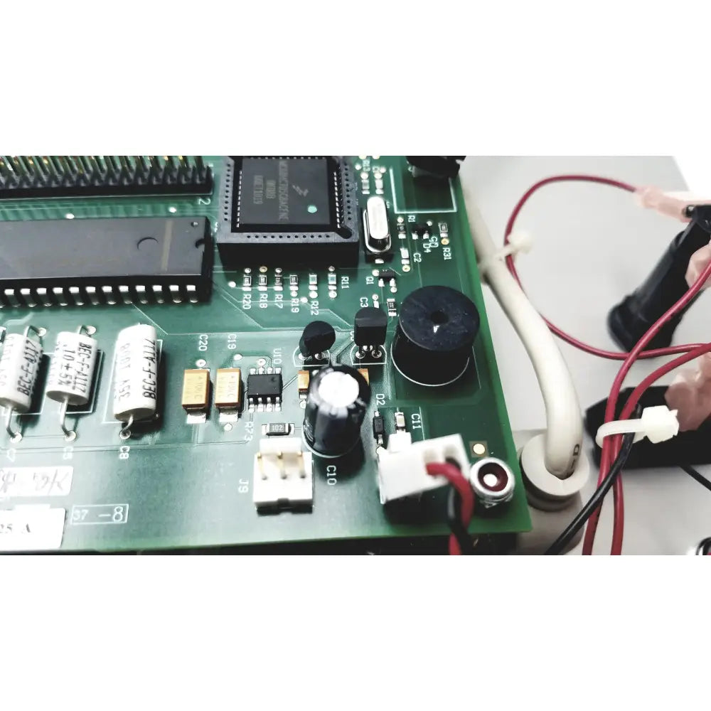 Green circuit board with black integrated circuits capacitors and resistors for Covidien Genius 2 checker calibrator reuse medical use