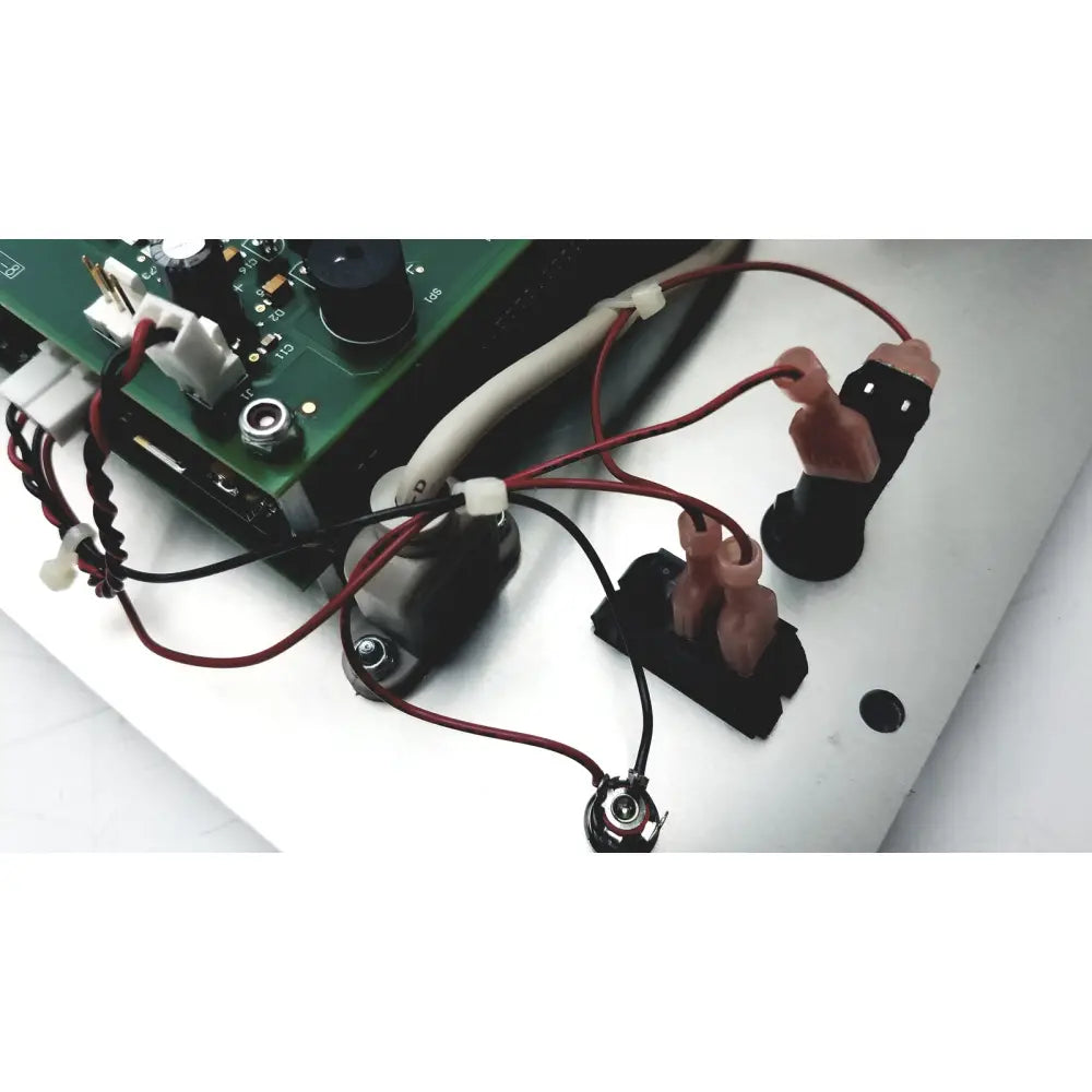 Black plastic connectors with pink silicone grips attached to red and black wires for covidien genius 2 checker calibrator test meters