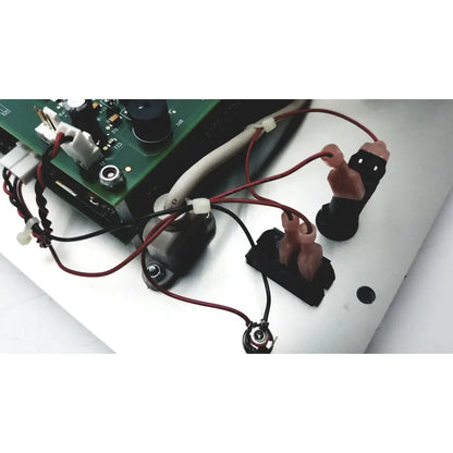 Black plastic connectors with pink silicone grips attached to red and black wires for covidien genius 2 checker calibrator test meters