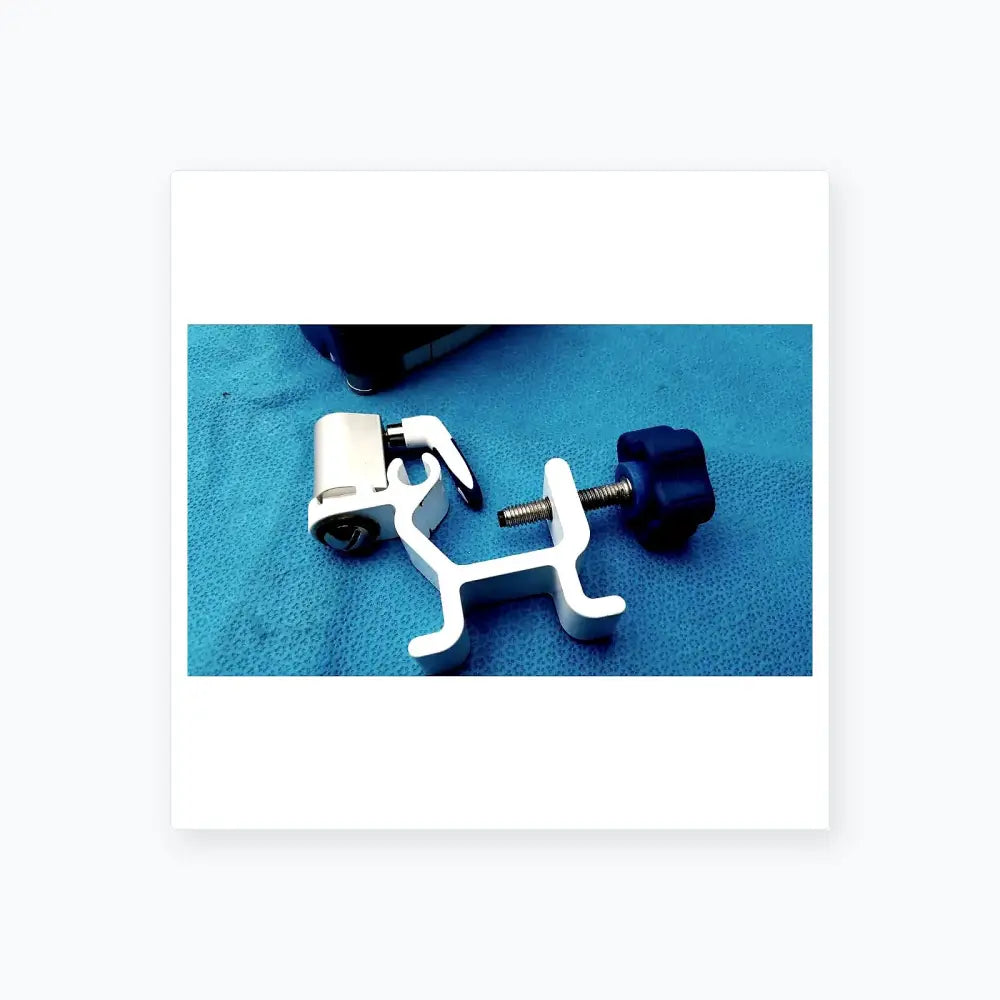 White plastic surgical instrument holder with blue knob and metallic screw for kangaroo joey flush pump pole clamp