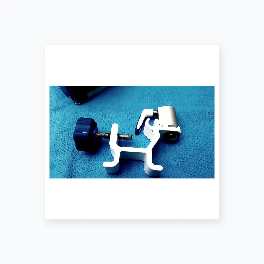White plastic surgical clamp with blue knob and metallic screw on kangaroo joey covidien flush pump pole clamp