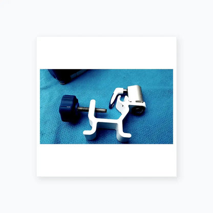 White plastic surgical clamp with blue knob and metallic screw on kangaroo joey covidien flush pump pole clamp