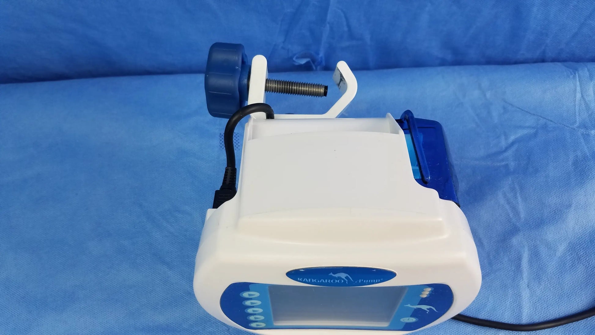 White and blue Covidien Kangaroo Joey nutrition feeding pump with digital display control buttons and pole clamp mechanism
