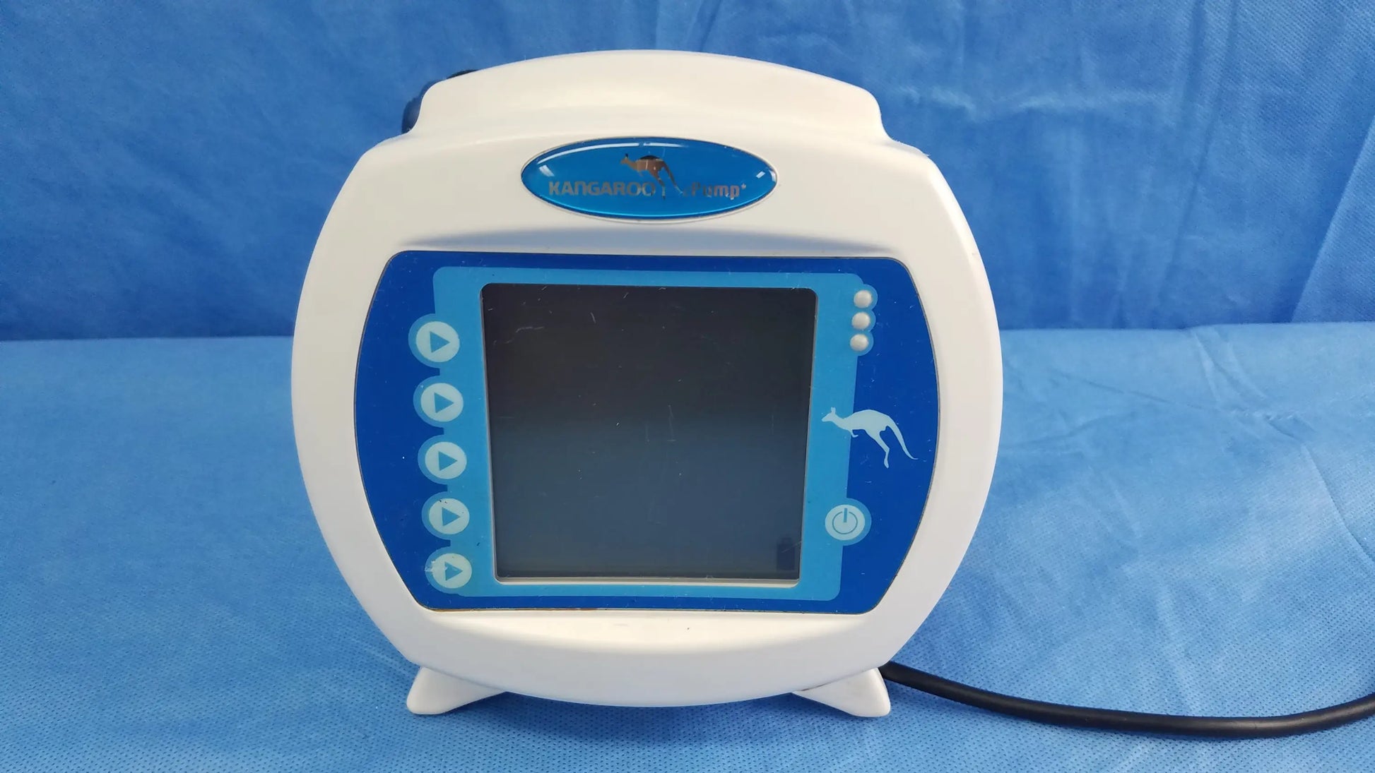 White and blue Covidien Kangaroo Joey nutrition feeding pump with rounded screen, control buttons, pole clamp, and power adapter