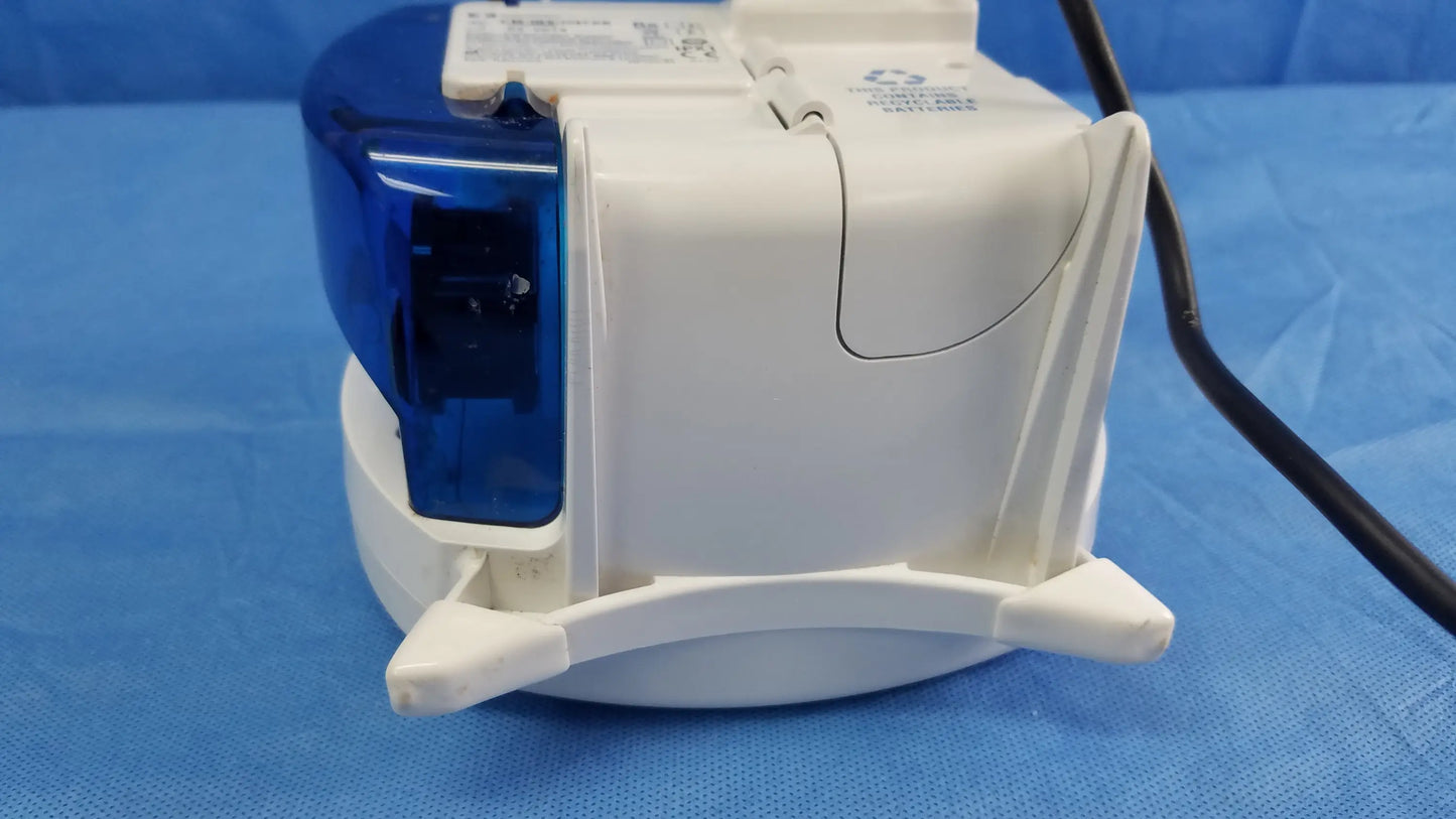 White and blue plastic covidien kangaroo joey nutrition feeding pump with hinged lid and molded grip handles for feeding pump use