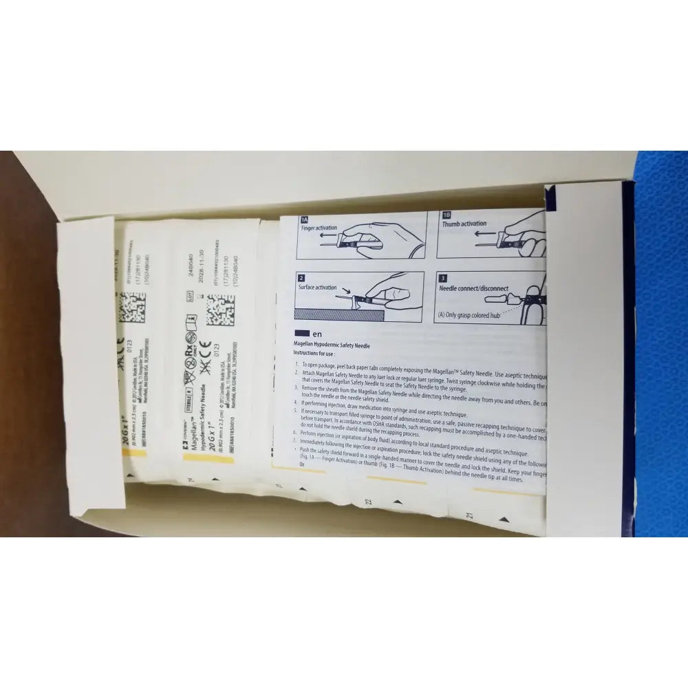 Covidien magellan hypodermic safety needles in a cardboard box with printed instructions and safety diagrams visible