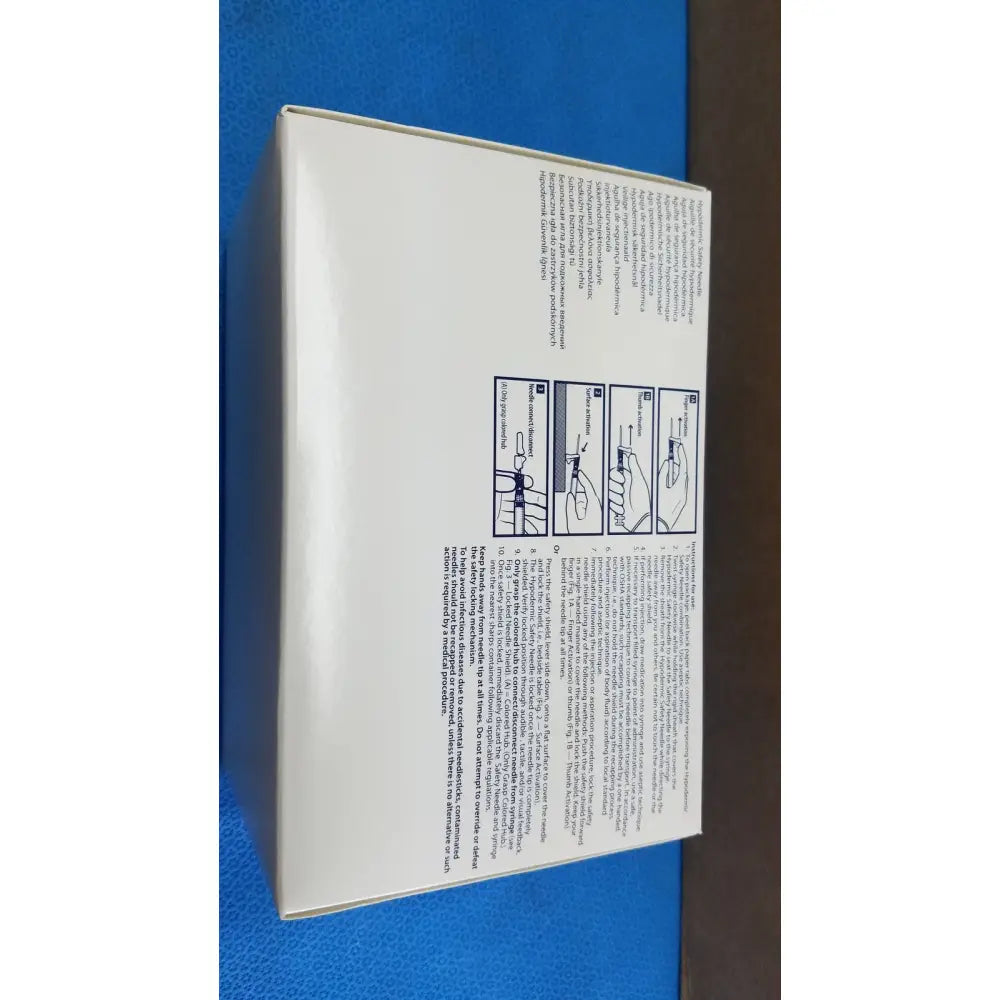 White rectangular box showing printed instructions and diagrams on the back of covidien magellan hypodermic safety needle