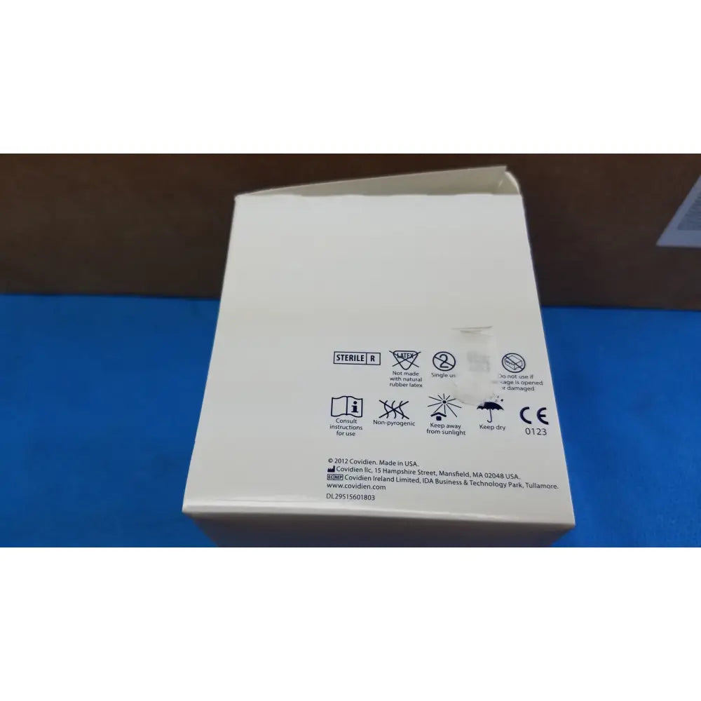 White cardboard box with black text and symbols showing sterile r and manufacturer info for covidien magellan hypodermic safety needle