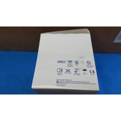 White cardboard box with black text and symbols showing sterile r and manufacturer info for covidien magellan hypodermic safety needle