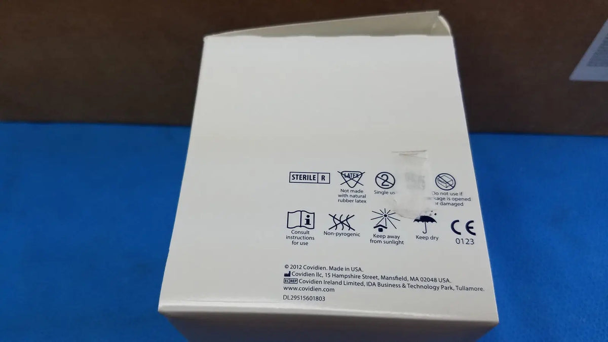 White cardboard box with black text and symbols showing sterile r and manufacturer info for covidien magellan hypodermic safety needle