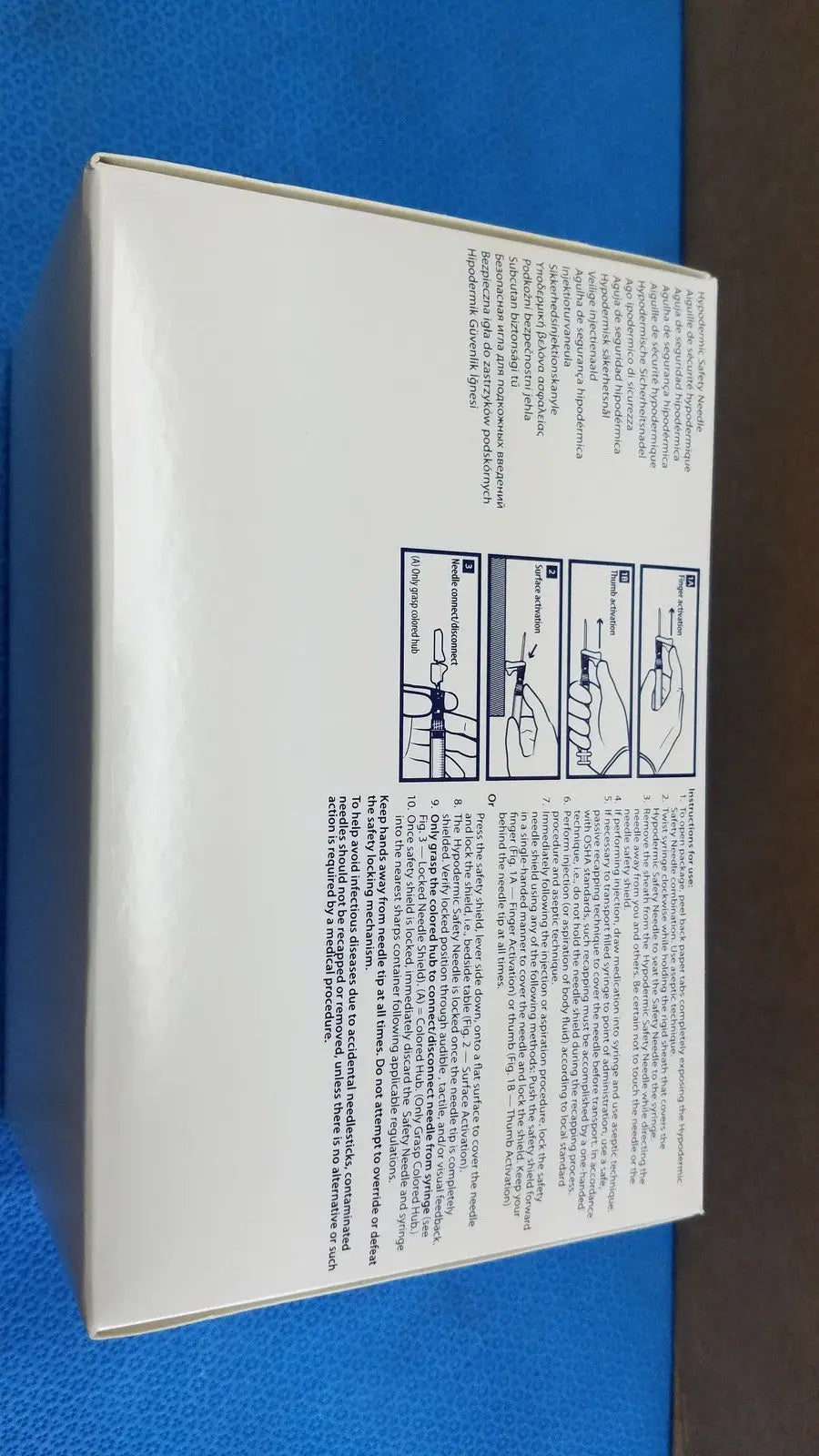 White rectangular box showing printed instructions and diagrams on the back of covidien magellan hypodermic safety needle