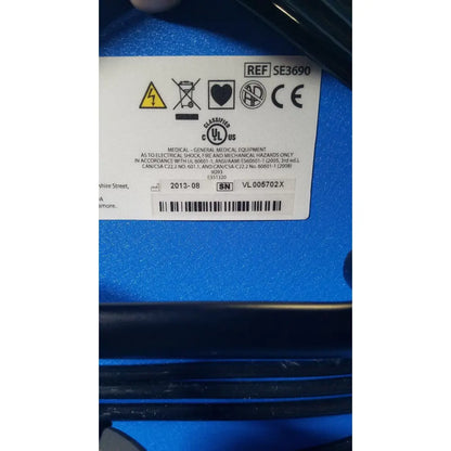 Blue covidien se3690 smoke evacuator device back with white label showing certification marks and serial number