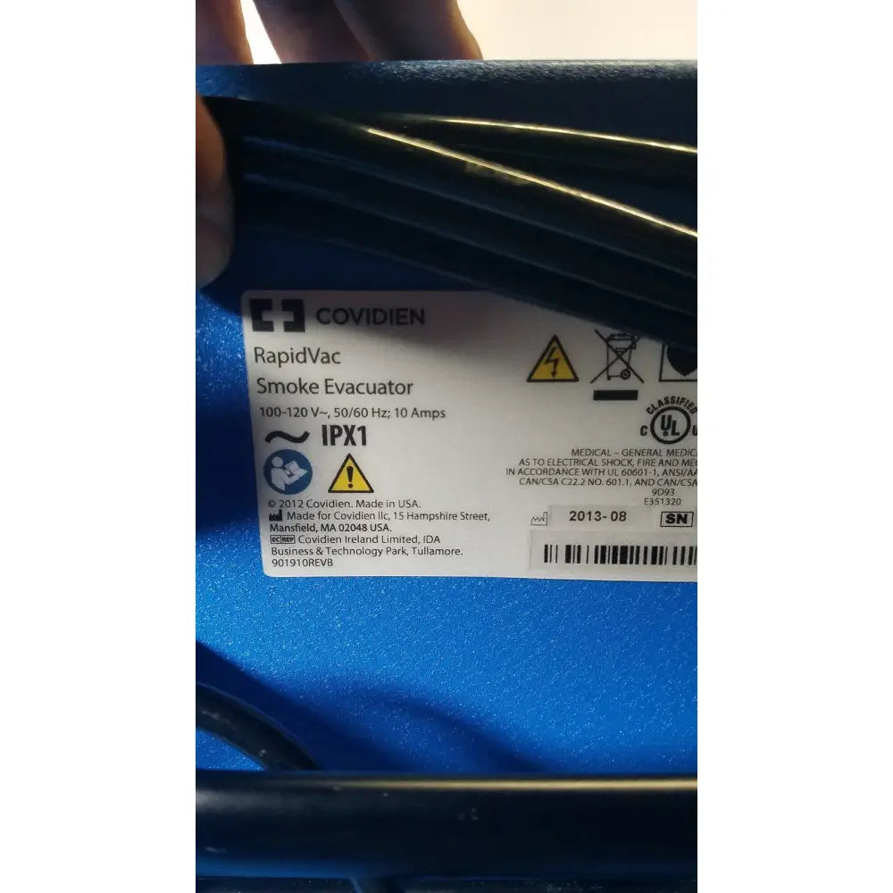 Blue plastic covidien se3690 smoke evacuator with ribbed texture and technical specifications label visible
