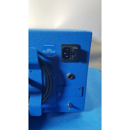 Blue textured power supply unit with black ac input plug and grounding screw on the back of covidien se3690 smoke evacuator