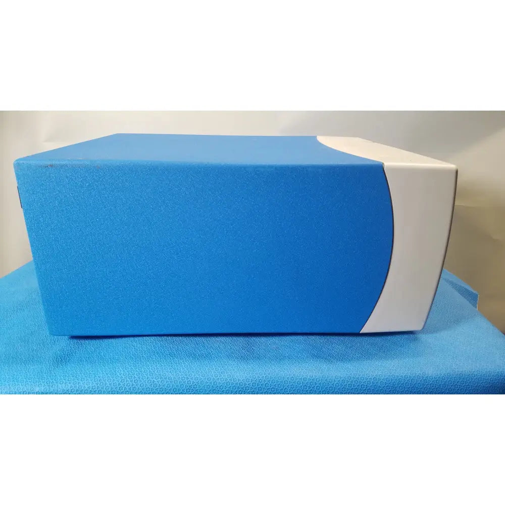 Blue and white rectangular covidien se3690 smoke evacuator with textured surface for surgical smoke management