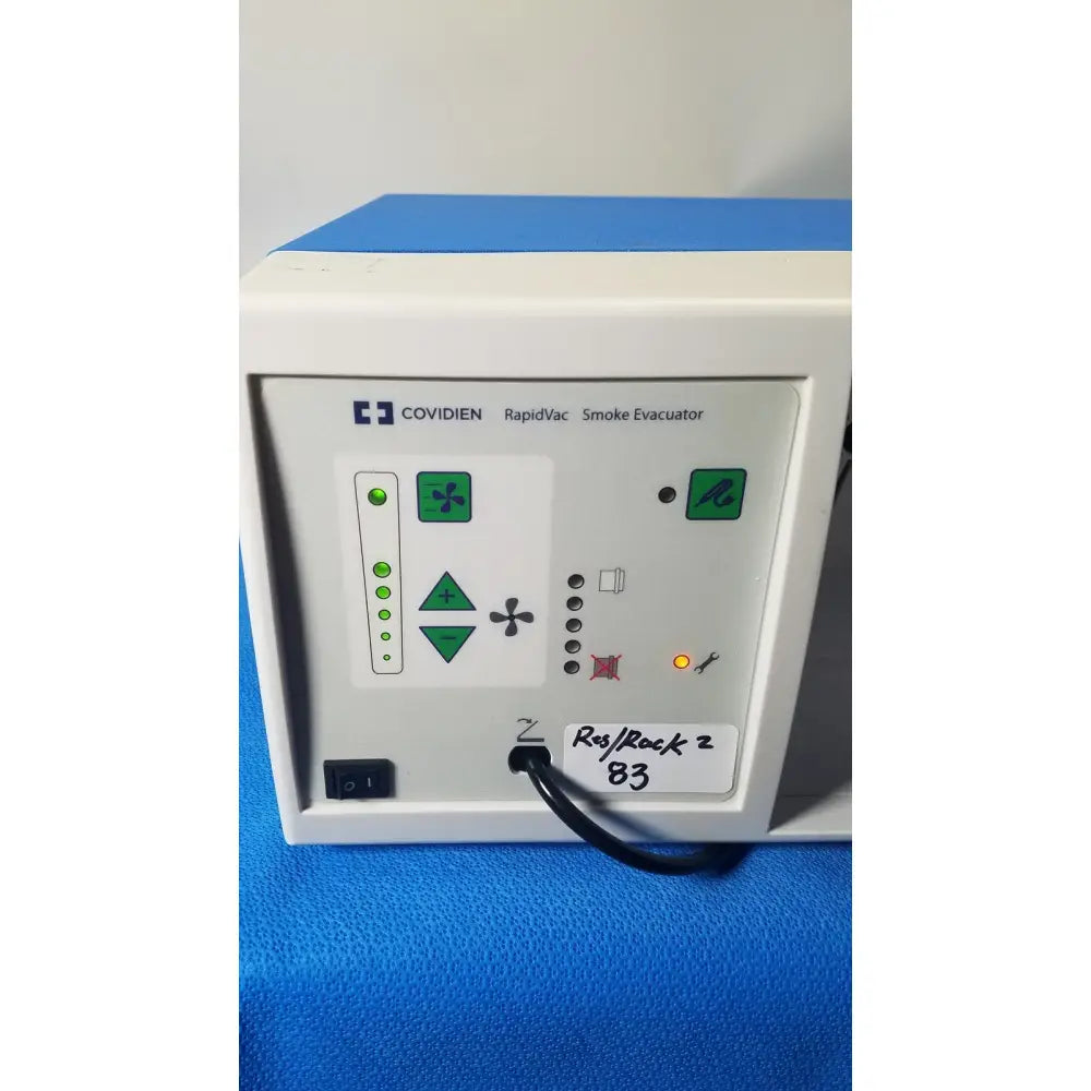 White plastic covidien se3690 smoke evacuator with green indicator lights and control buttons for surgical use