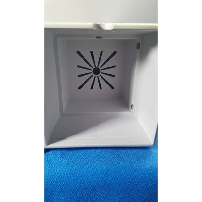 White plastic box with black radial vent pattern on interior of covidien se3690 smoke evacuator device