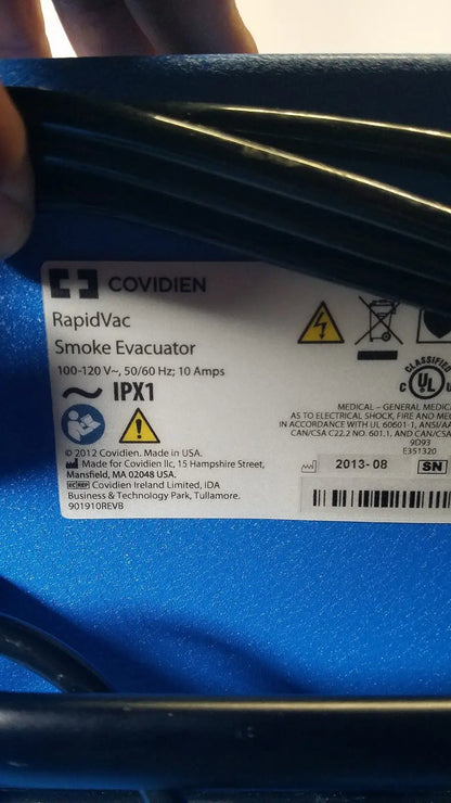 Blue plastic covidien se3690 smoke evacuator with ribbed texture and technical specifications label visible