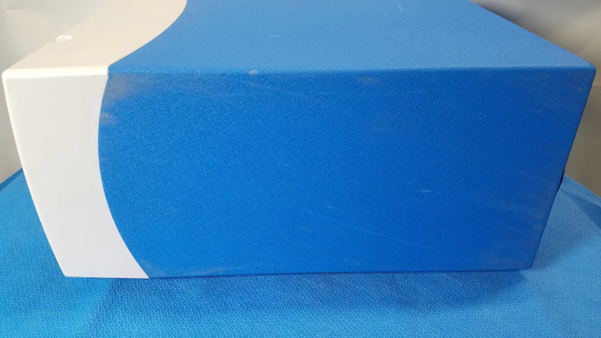 Blue and white rectangular covidien se3690 smoke evacuator box with curved design for surgical smoke removal