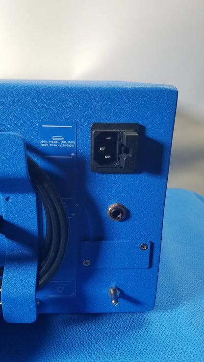 Blue textured power supply unit with black ac input plug and grounding screw on the back of covidien se3690 smoke evacuator