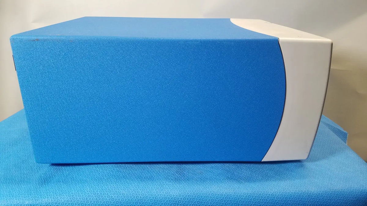Blue and white rectangular covidien se3690 smoke evacuator with textured surface for surgical smoke management