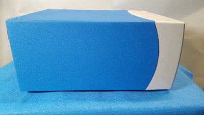 Blue and white rectangular covidien se3690 smoke evacuator with textured surface for surgical smoke management