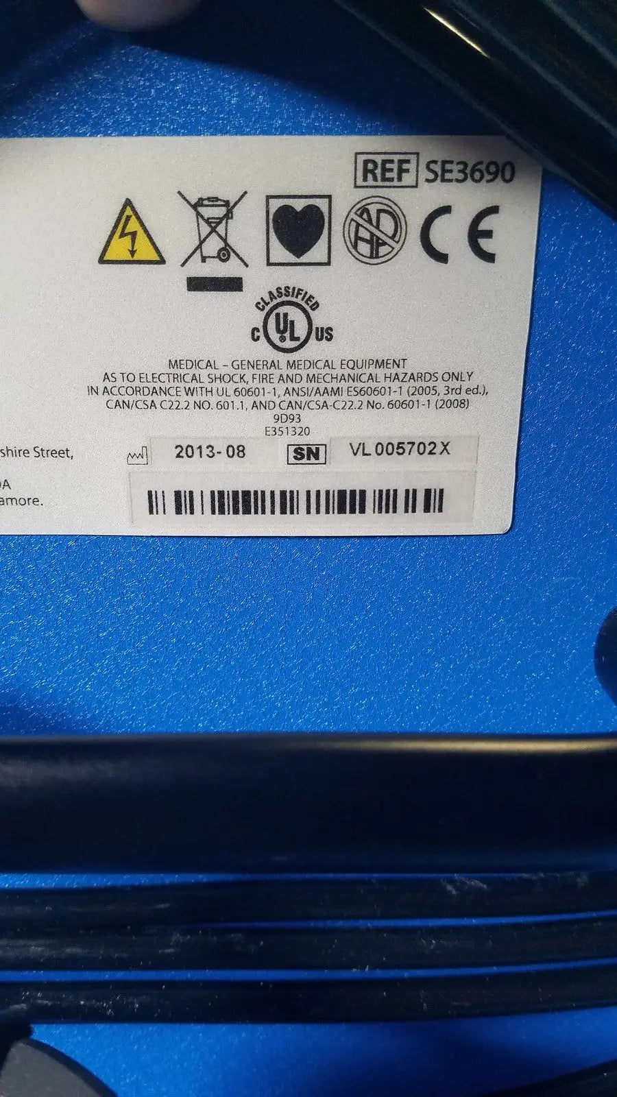 Blue covidien se3690 smoke evacuator device back with white label showing certification marks and serial number