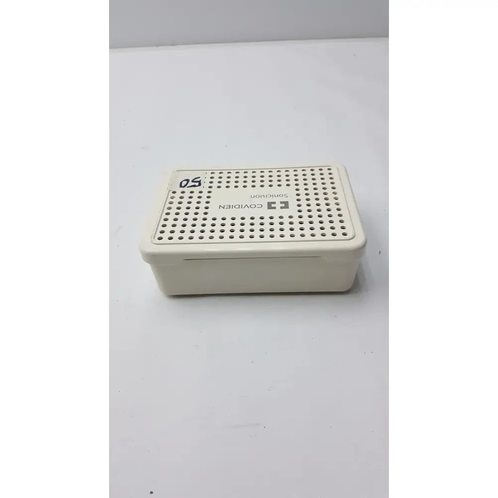 Cream-colored plastic covidien sonicision sterilization container tray with perforated lid for secure sterilization use