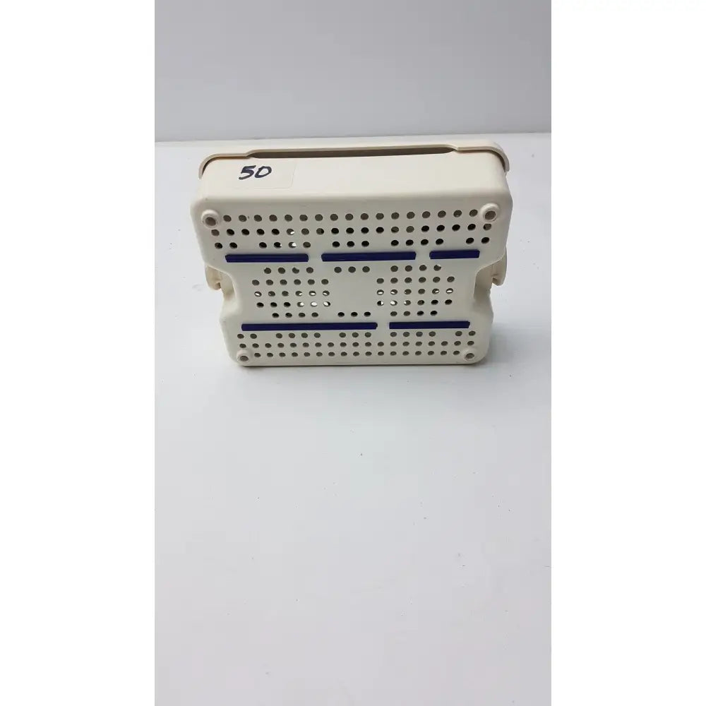 Beige plastic covidien sonicision sterilization container tray with blue stripes and perforated surface for surgical use