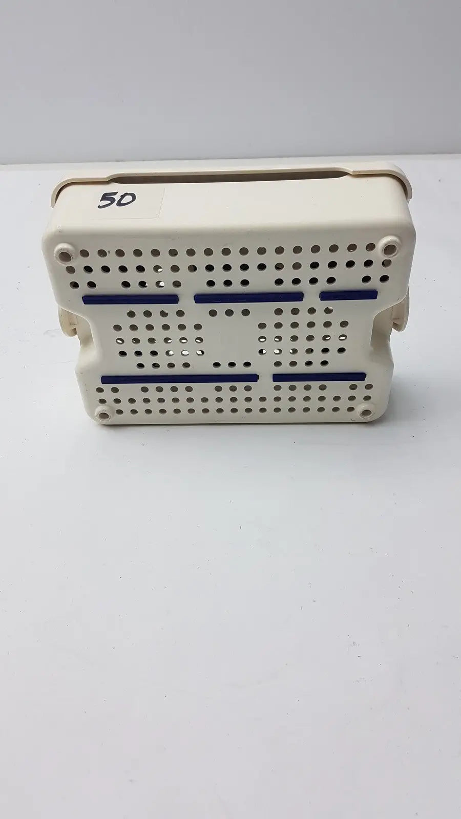 Beige plastic covidien sonicision sterilization container tray with blue stripes and perforated surface for surgical use