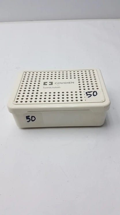 Cream-colored plastic covidien sonicision sterilization container tray with perforated lid for sonicision sterilization use