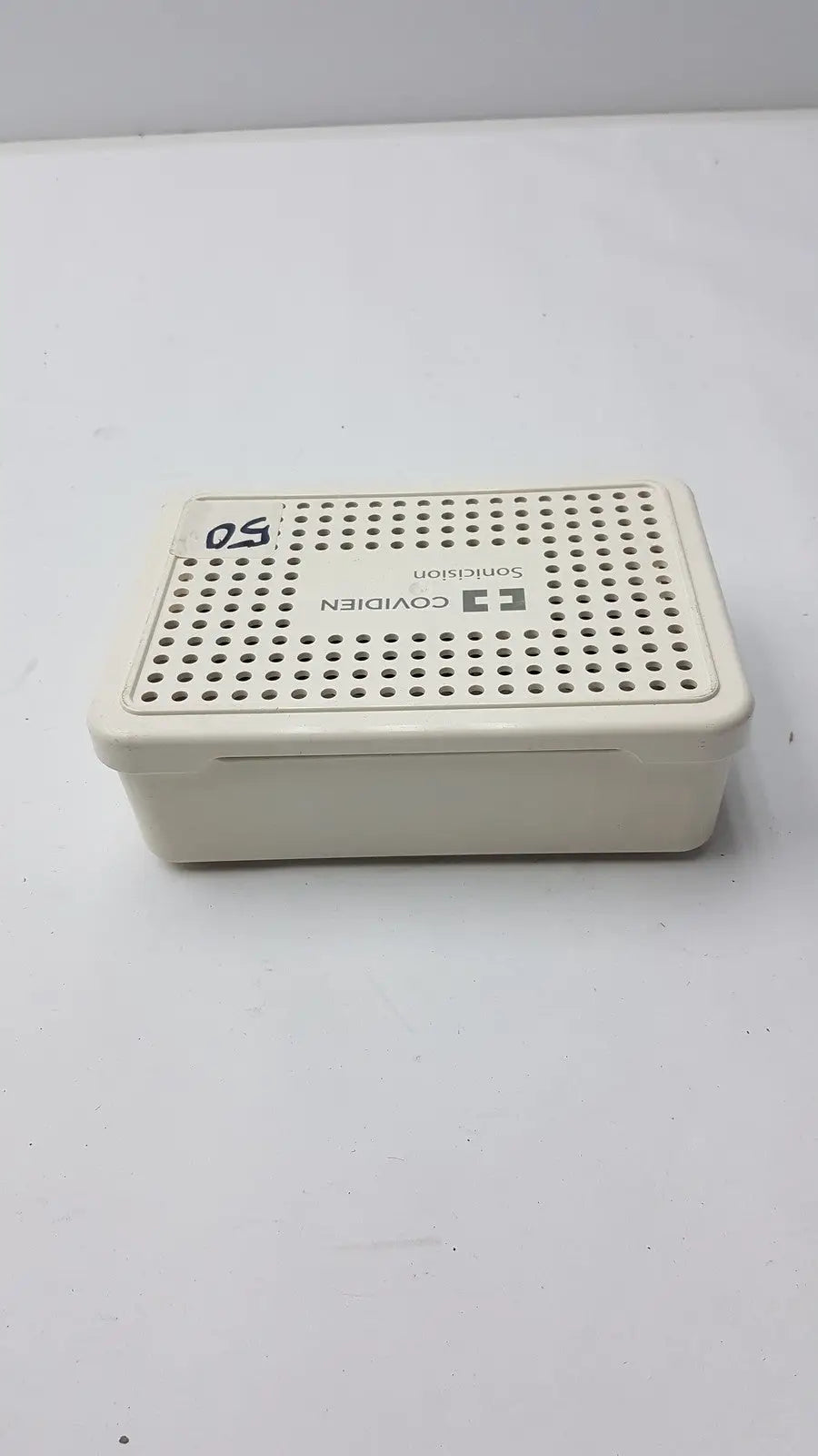 Cream-colored plastic covidien sonicision sterilization container tray with perforated lid for secure sterilization use