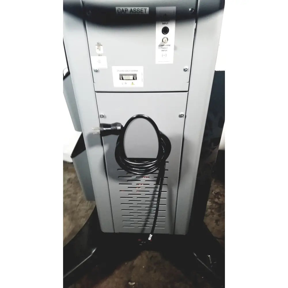 Gray metal industrial printer with coiled black power cord on the side of covidien super dimension i logic in reach navigation system