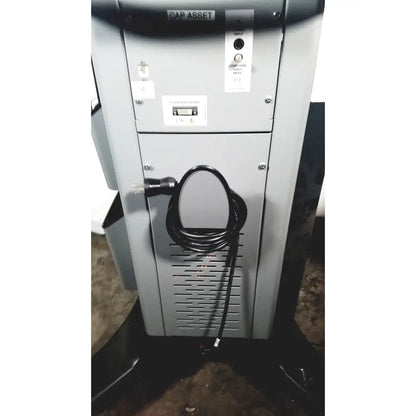 Gray metal industrial printer with coiled black power cord on the side of covidien super dimension i logic in reach navigation system