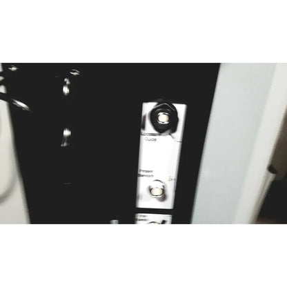 Black plastic panel with white labels and silver circular components on the back of covidien super dimension i logic in reach navigation system
