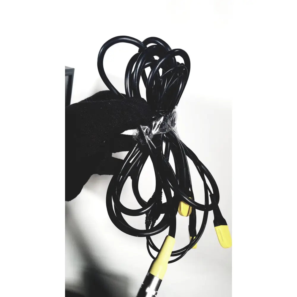 A coiled black cable with yellow connectors wrapped in clear plastic for the covidien super dimension navigation system