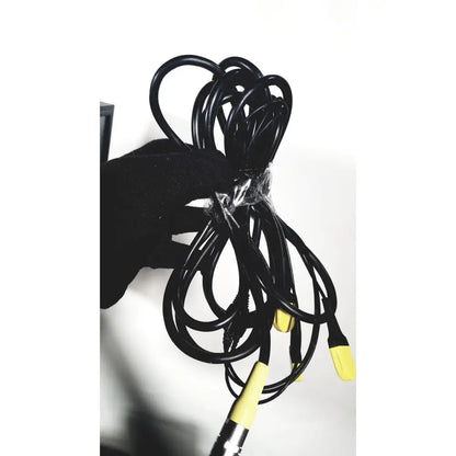 A coiled black cable with yellow connectors wrapped in clear plastic for the covidien super dimension navigation system
