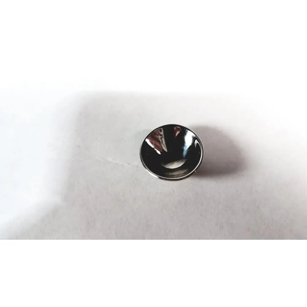 A sleek circular black glossy cox ii ocular laser eye shield without handle for surgical ophthalmic use