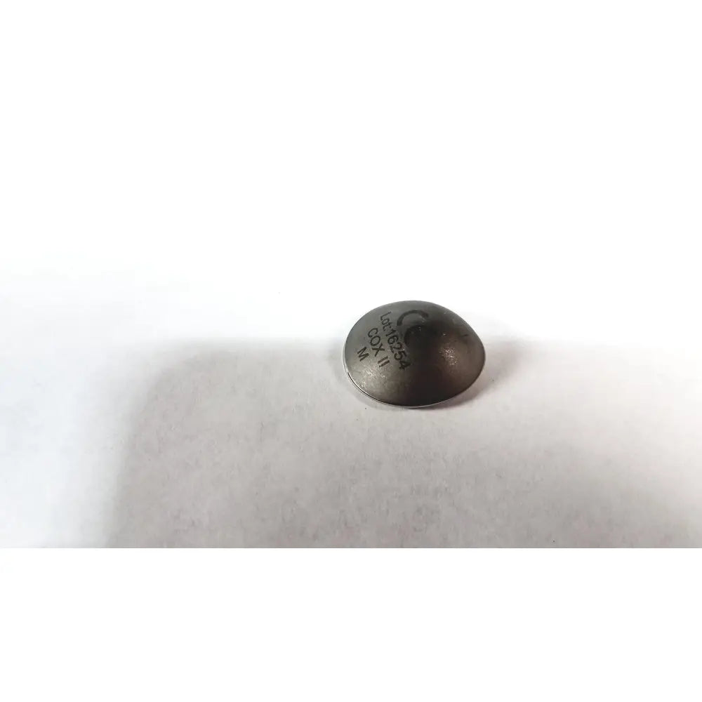 Dark gray circular metal cox ii ocular laser eye shield without handle with engraved markings for surgical use