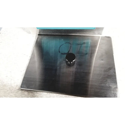Black cylindrical magnet resting on brushed stainless steel surface of crest ultrasonic powersonic cleaner model p1100d